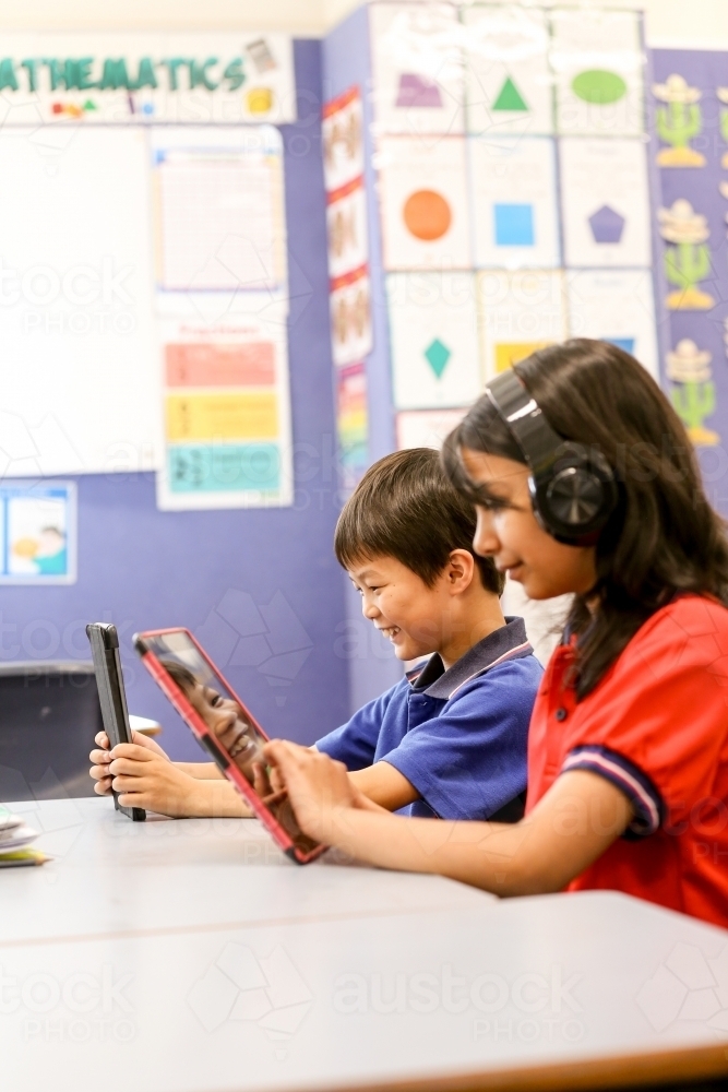 students in the classroom with headphones and iPads - Australian Stock Image