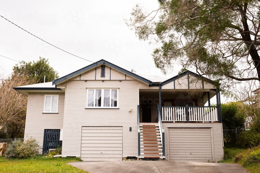 suburban post war home in Brisbane with garages underneath - Australian Stock Image