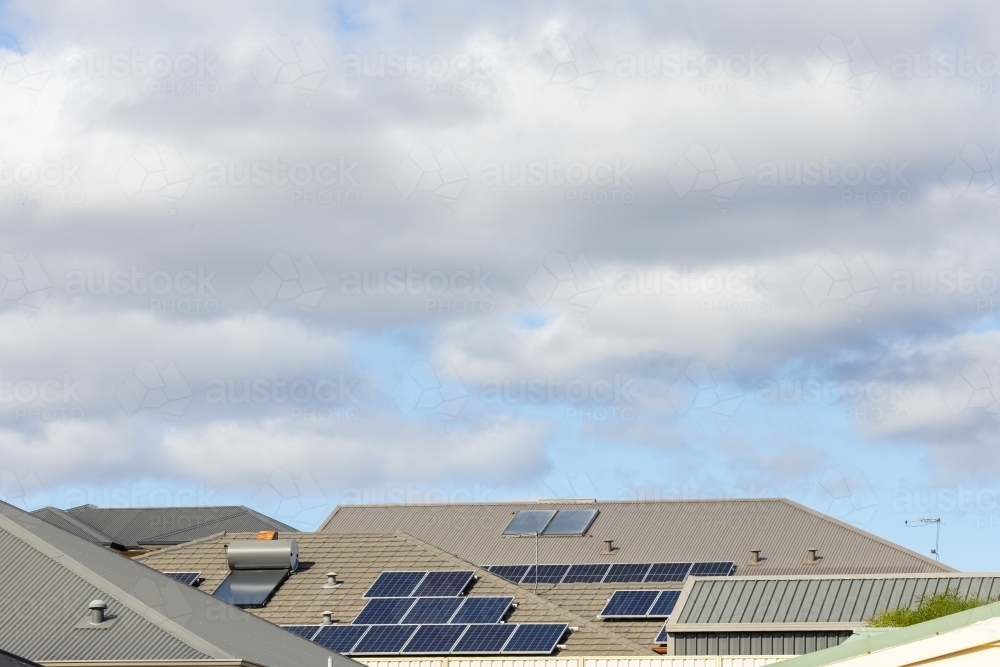 suburban roofs with solar panels and solar hot water systems - Australian Stock Image