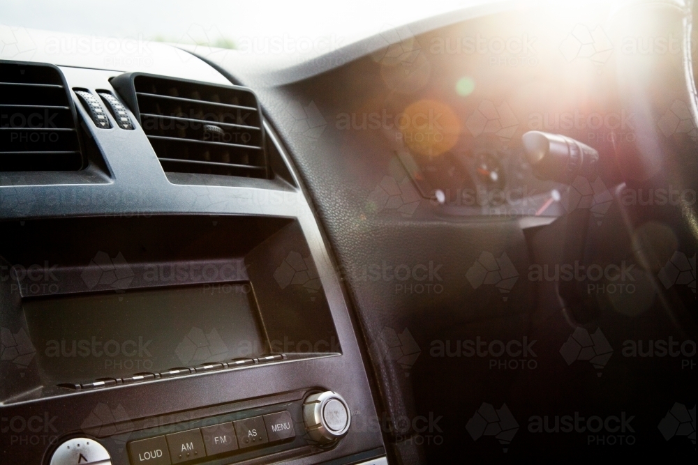 Sun flare over dashboard and speedo of car - Australian Stock Image