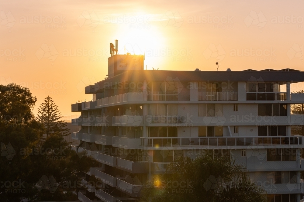 Sun setting behind apartment building in Port Macquarie on NSW North Coast - Australian Stock Image