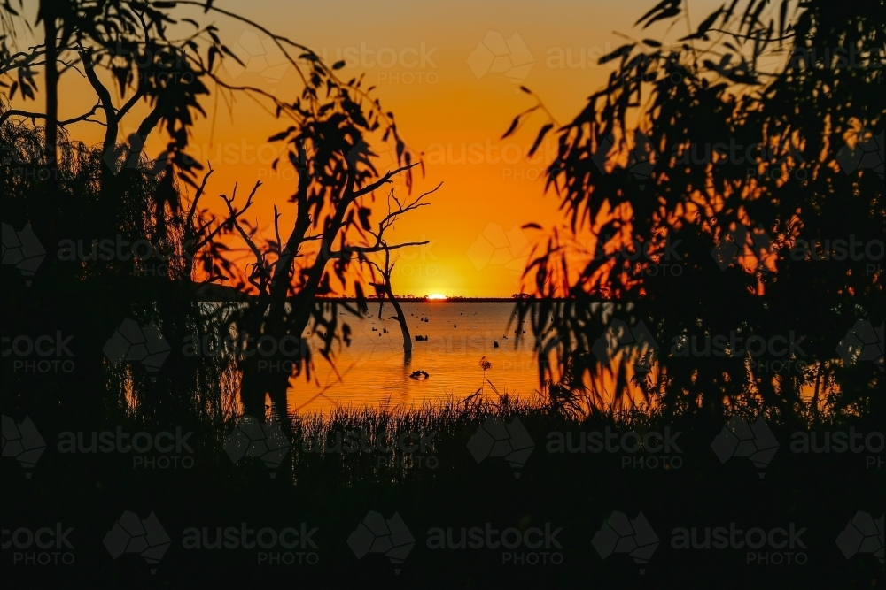 Sun setting over Kow Swamp in Central Victoria - Australian Stock Image