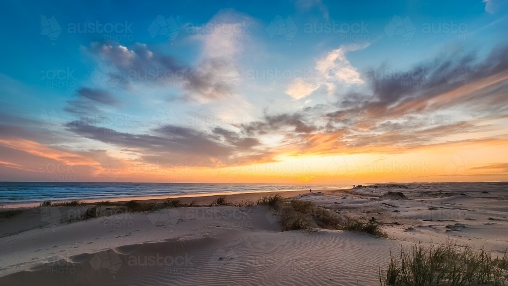 Sun setting over the sand dunes at Birubi Beach at Port Stephens, NSW - Australian Stock Image