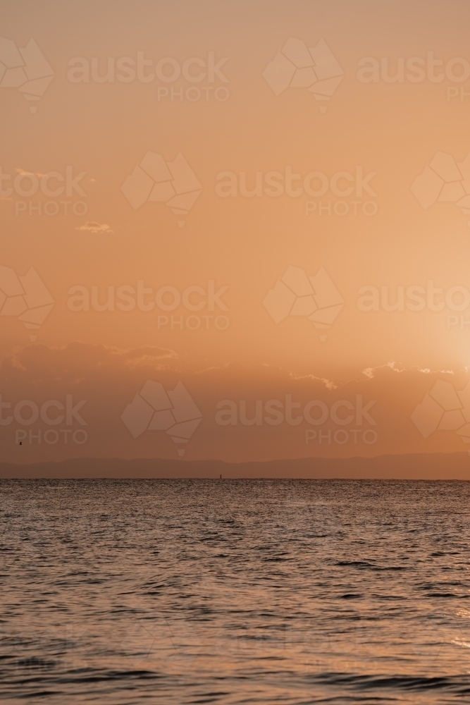 Sun setting over the water at Moreton Bay - Australian Stock Image