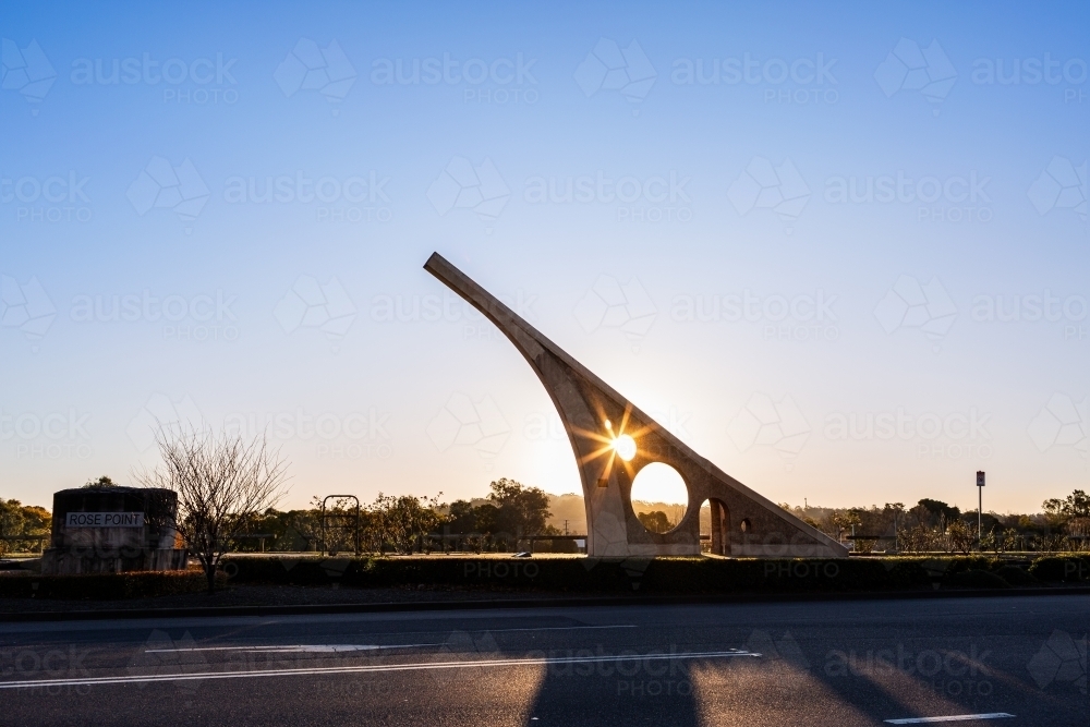 Image of Sundial casting shadow over road at sunset in town of ...