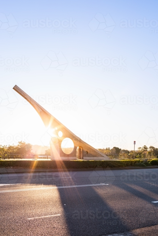 Image of Sundial casting shadow over road at sunset in town of ...