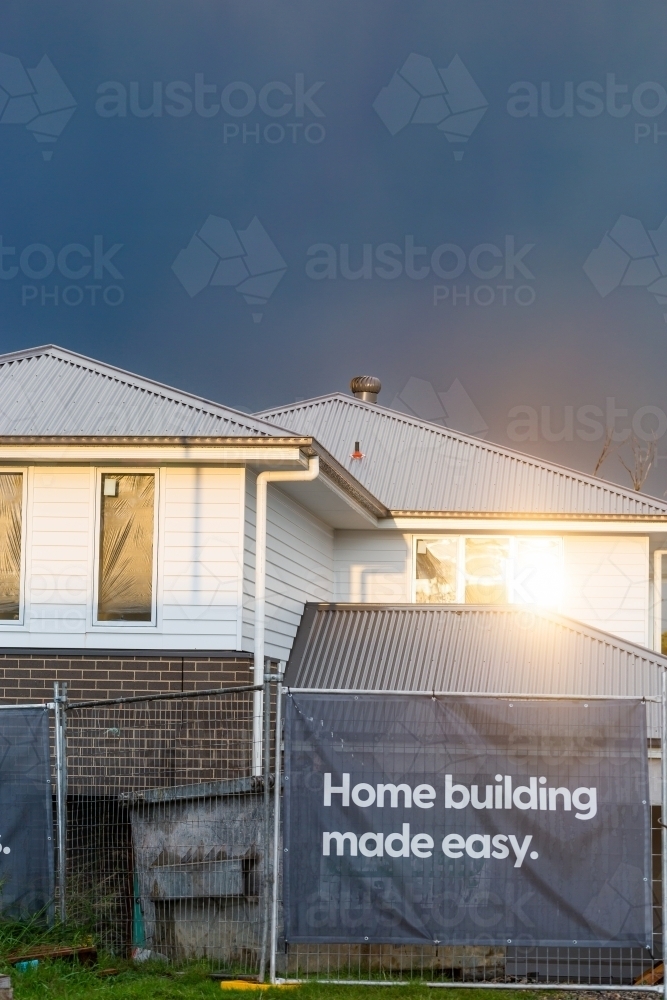 Sunlight reflecting off window of new house build under construction - Australian Stock Image