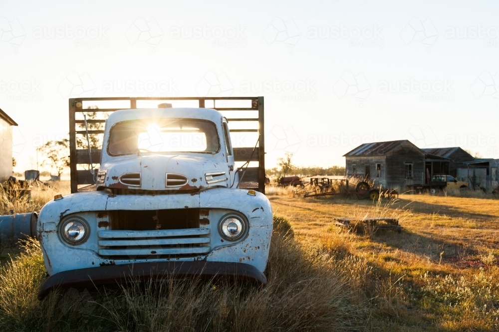 Sunlight shining through old vintage truck in country farm paddock - Australian Stock Image