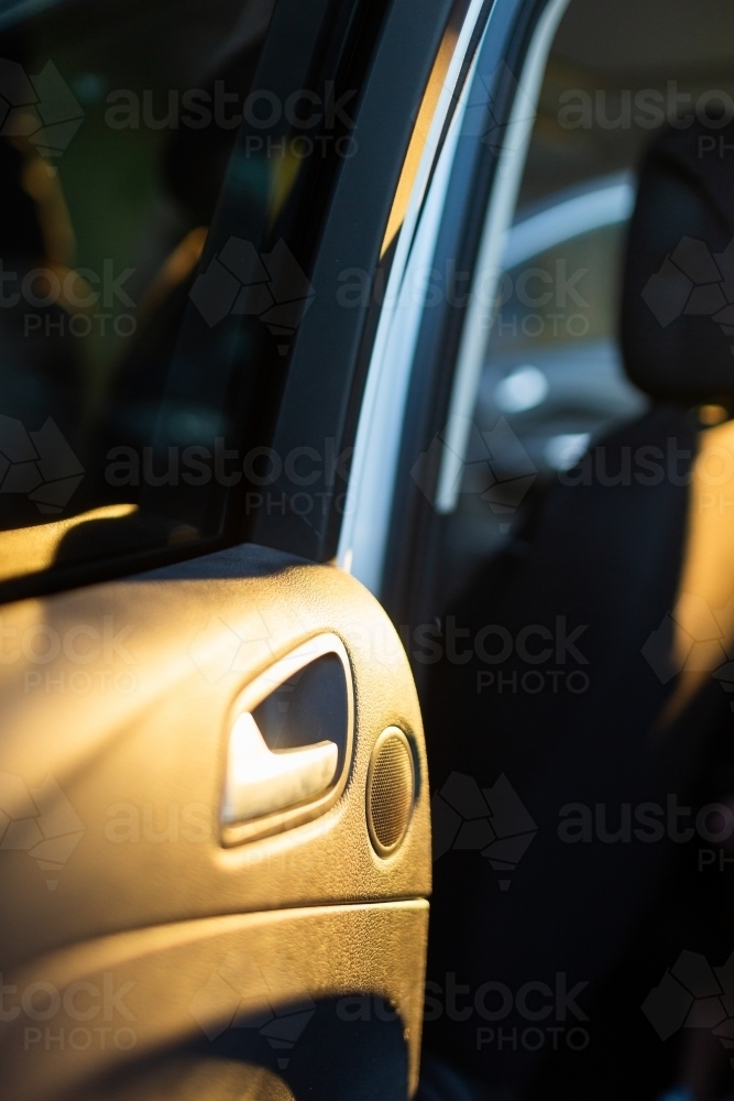 Sunlit car door handle and window - Australian Stock Image