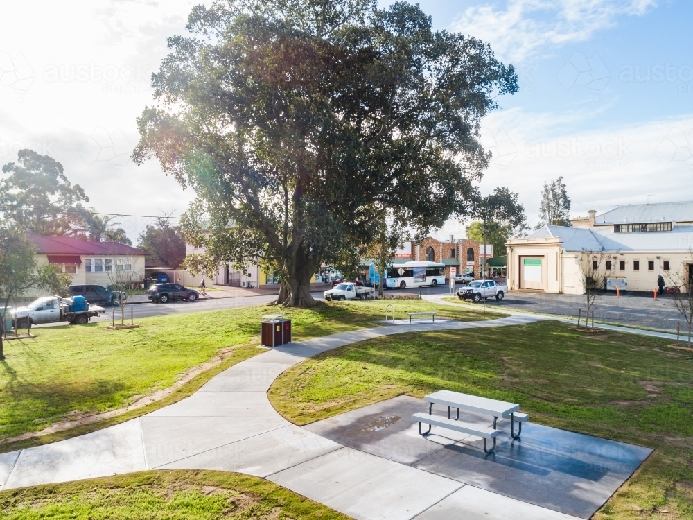 Sunlit park in town with new laid grass turf - Australian Stock Image