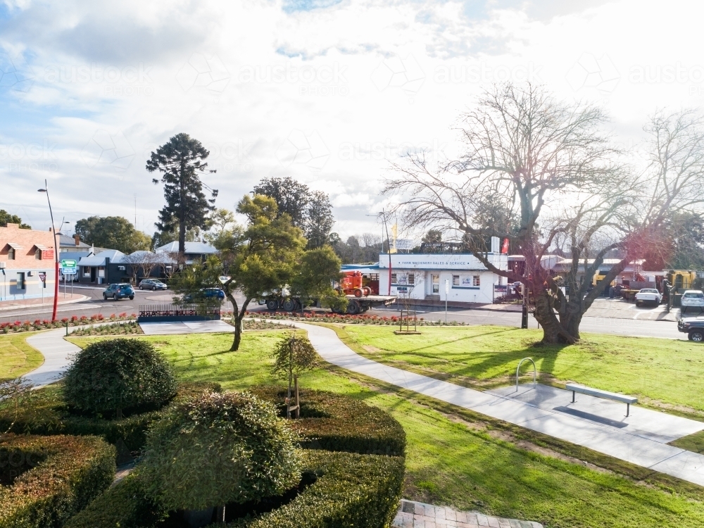 Sunlit park in town with new laid grass turf - Australian Stock Image