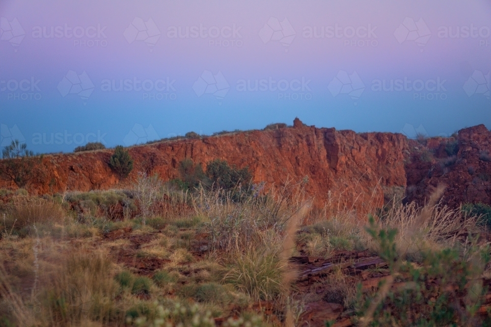 Sunrise glow from the top of Mount Bruce in Karijini Western Australia. - Australian Stock Image