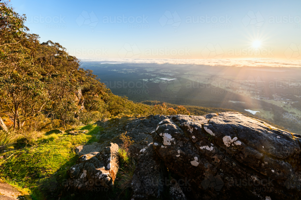 sunrise landscape with boulder in foreground from Boroka Lookout, Grampians, Victoria, Australia - Australian Stock Image