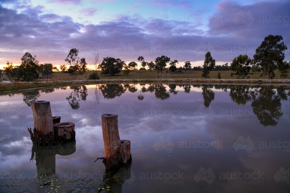 Sunrise over a farm dam. - Australian Stock Image