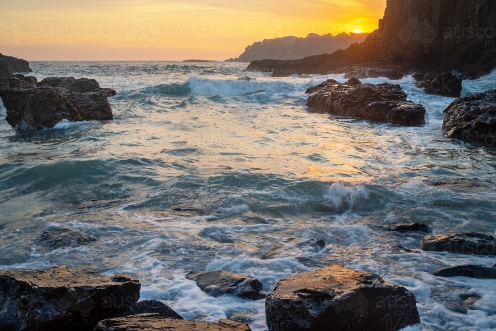 Sunrise over rocks and ocean at Kiama - Australian Stock Image