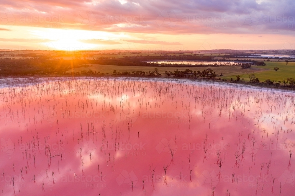 Sunset and a pink salt lake in Western Australia. - Australian Stock Image