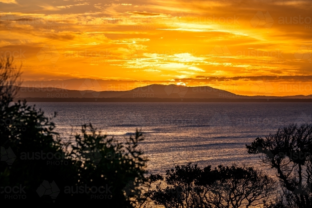 Sunset coastal landscape across Bustard Bay - Australian Stock Image