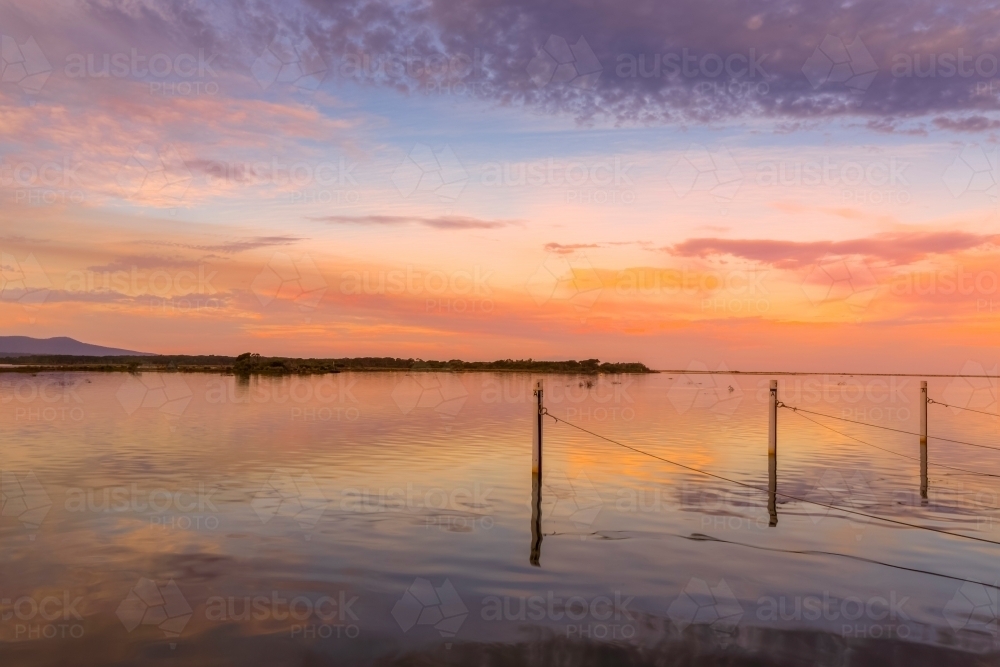 Sunset colours on the Mallacoota inlet a popular fishing spot in Australia - Australian Stock Image