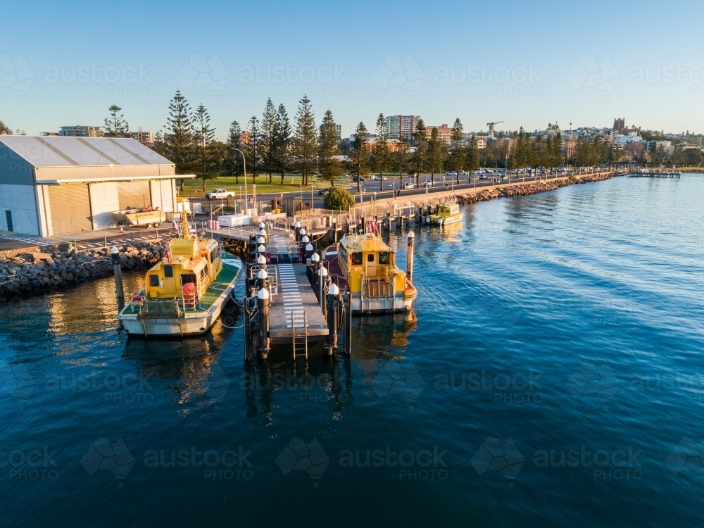 Sunset light on boats at Newcastle foreshore seen from aerial view - Australian Stock Image