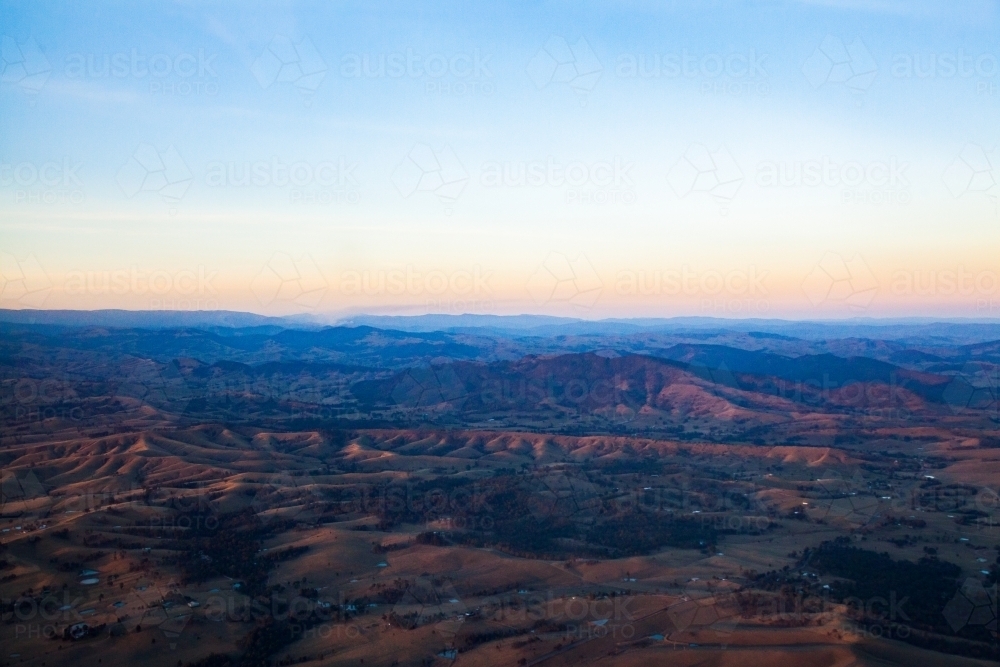 Sunset light on hilly australian landscape - Australian Stock Image