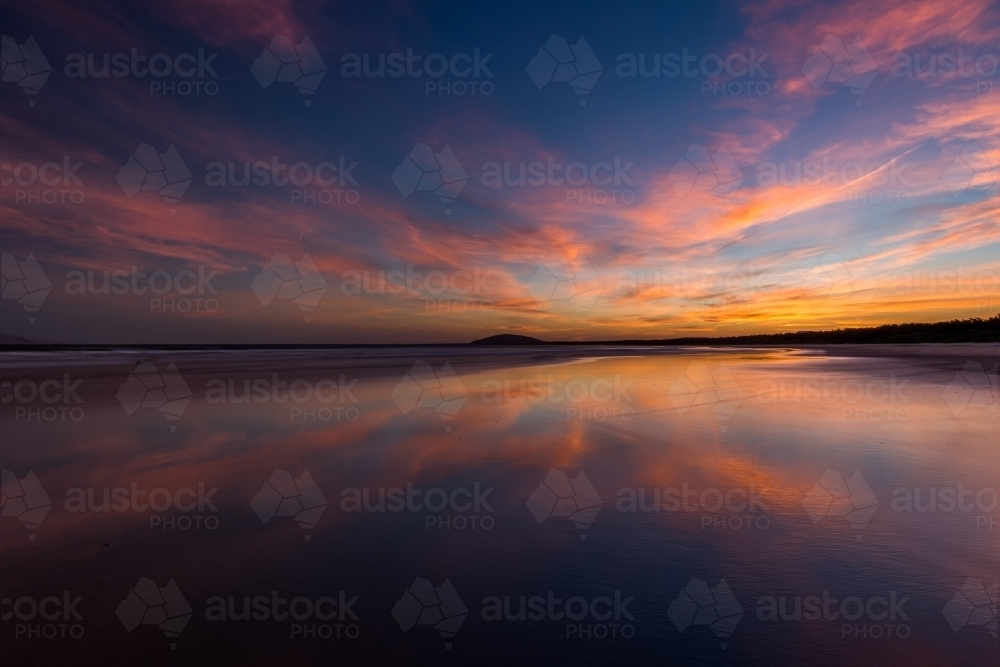 Sunset over calm ocean water - Australian Stock Image