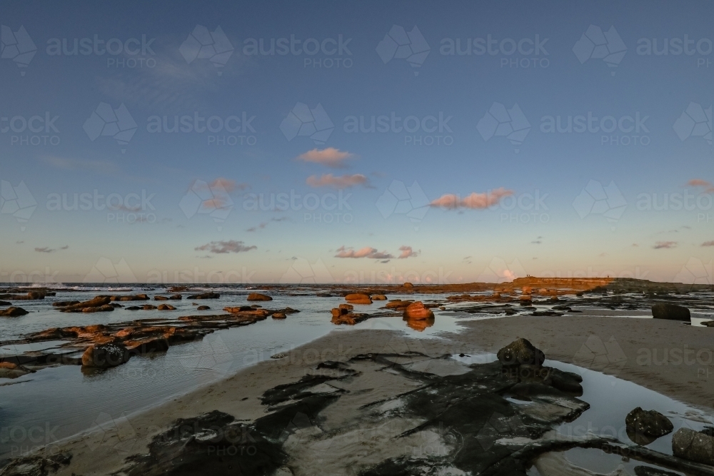 Sunset over rocky shelf at Norah Head, NSW Australia - Australian Stock Image