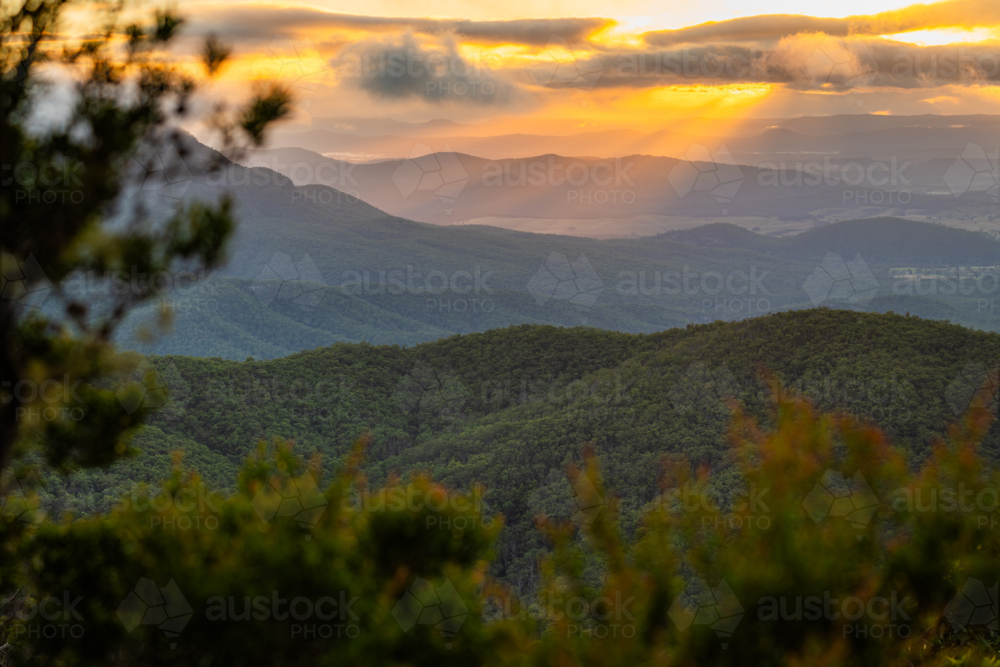 Sunset rays over scenic mountain landscape - Australian Stock Image