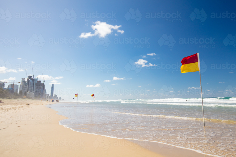 Surf lifesaving flags on a hot sunny day in Broadbeach, Gold Coast, Queensland, Australia - Australian Stock Image