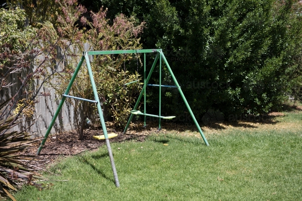 Swing set in backyard - Australian Stock Image