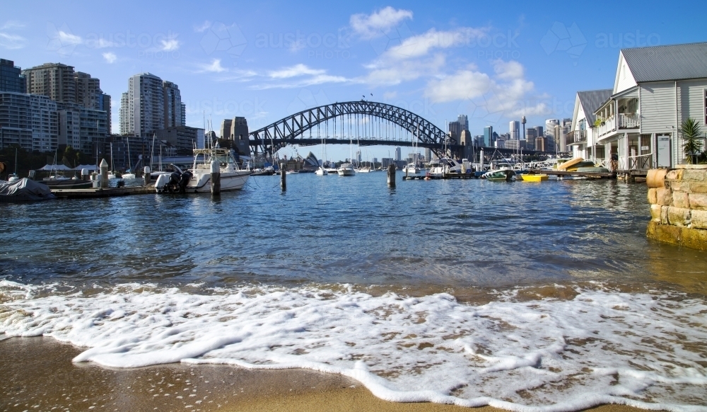 Sydney Harbour Bridge with boats and shore in the foreground - Australian Stock Image