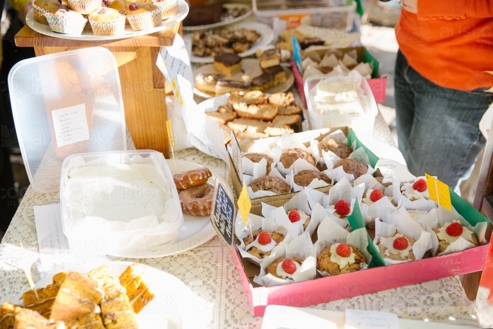 Table full of different baked goods, muffins, cookies and cakes - Australian Stock Image