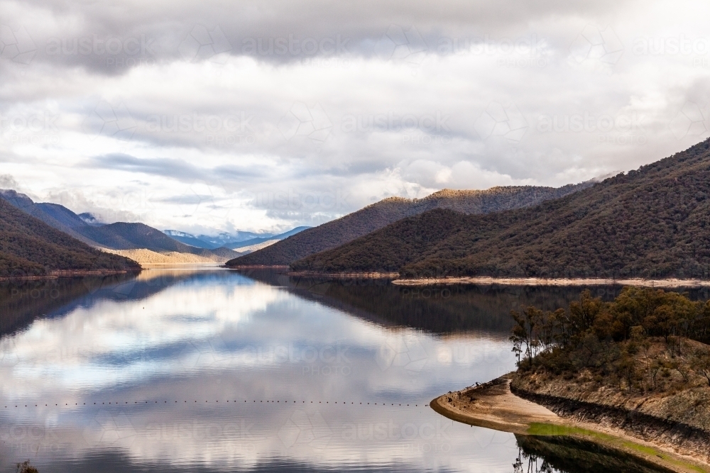 Talbingo Dam scenery with still water on overcast day in early winter - Australian Stock Image