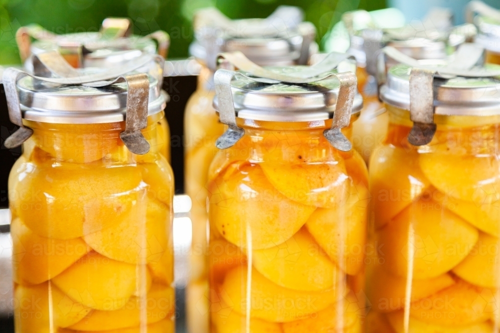 Tasty fresh homemade preserved apricot fruit in glass jar - Australian Stock Image