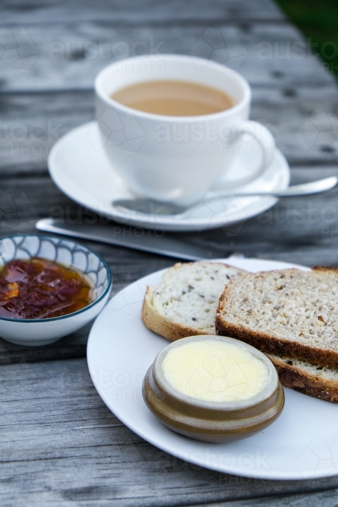 Tea and fresh baked bread with jam and butter - Australian Stock Image