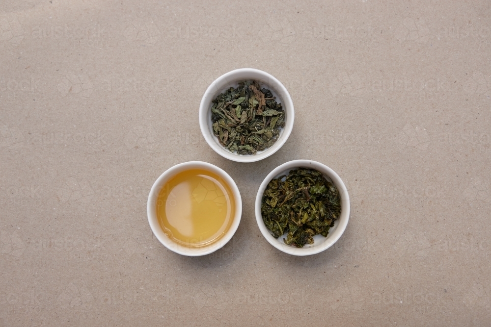 Tea leaves and drink on table - Australian Stock Image