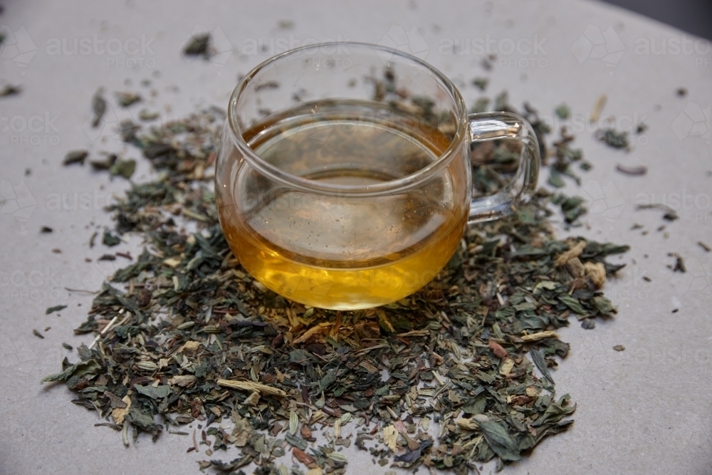 Tea leaves and drink on table - Australian Stock Image