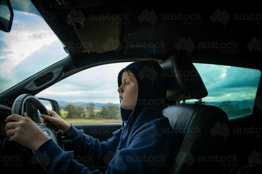 Teen boy driving ute on farm - Australian Stock Image