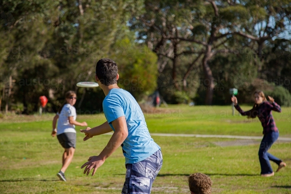 Teen boy throwing frisbee for game - Australian Stock Image