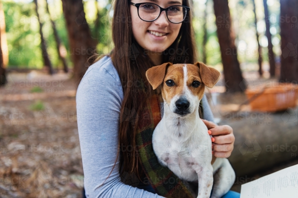 teen girl in forest with her dog - Australian Stock Image