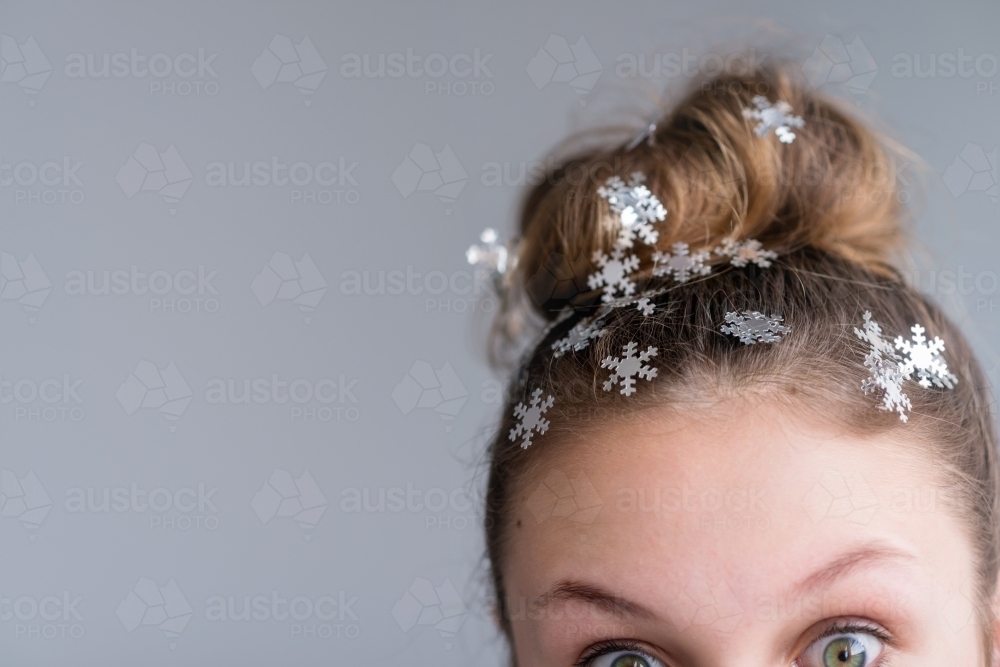 teen with hair bun and snowflakes - Australian Stock Image