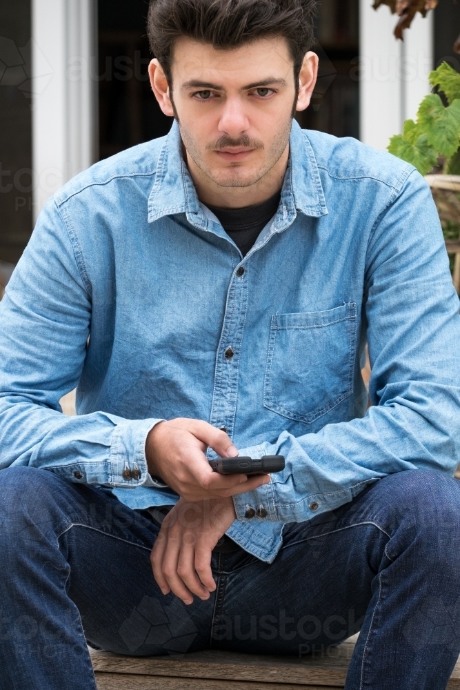 Teenage boy looks at camera - Australian Stock Image