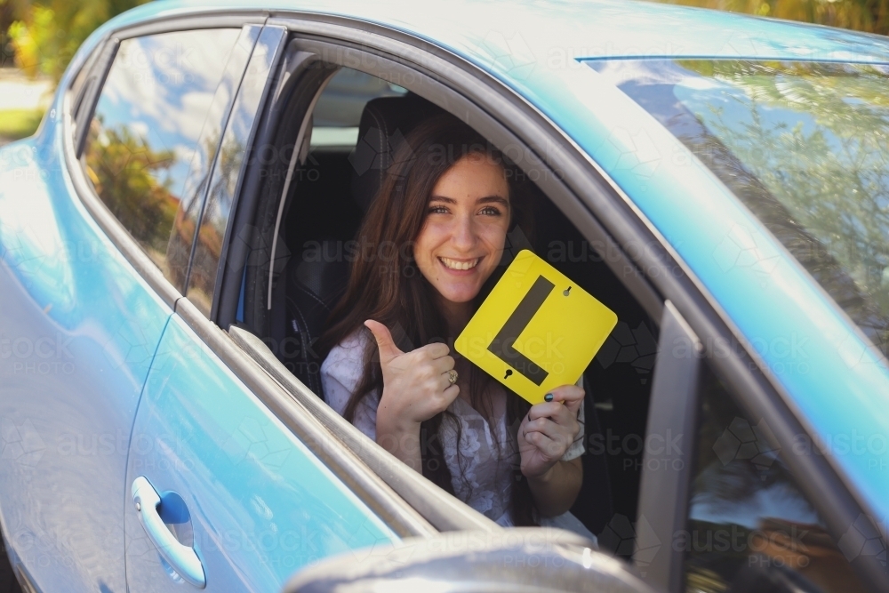 Teenage girl holding L plate - Australian Stock Image