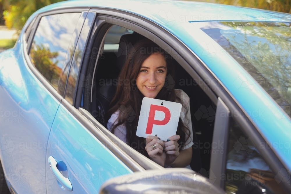 Teenage girl holding P plate - Australian Stock Image