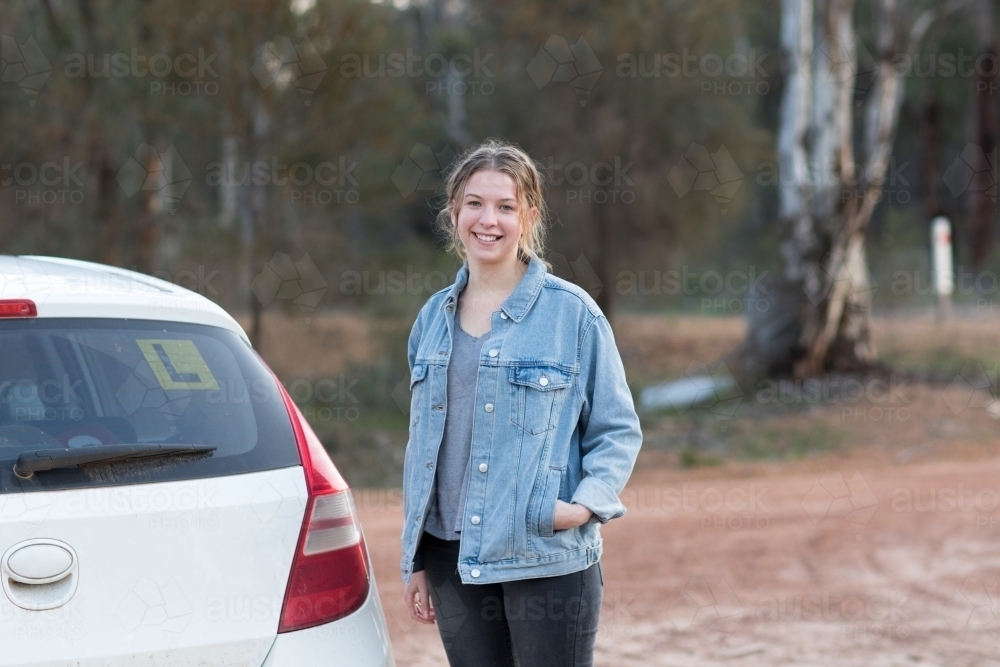 Teenage girl next to car with L plates - Australian Stock Image
