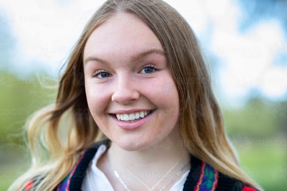 teenage girl smiling and looking at the camera - Australian Stock Image