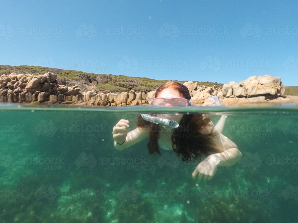 Teenage girl snorkelling in the ocean - Australian Stock Image