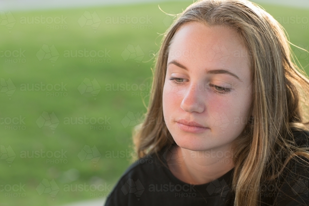 Teenage girl with eyes downcast - Australian Stock Image