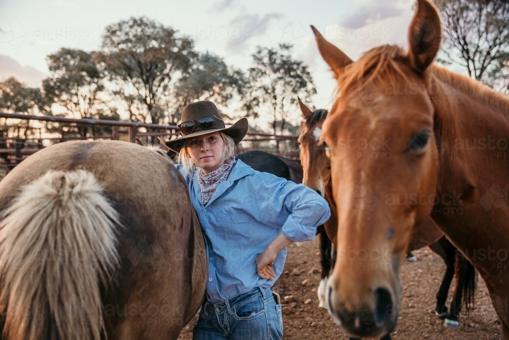 Teenage girl with horses on the farm - Australian Stock Image