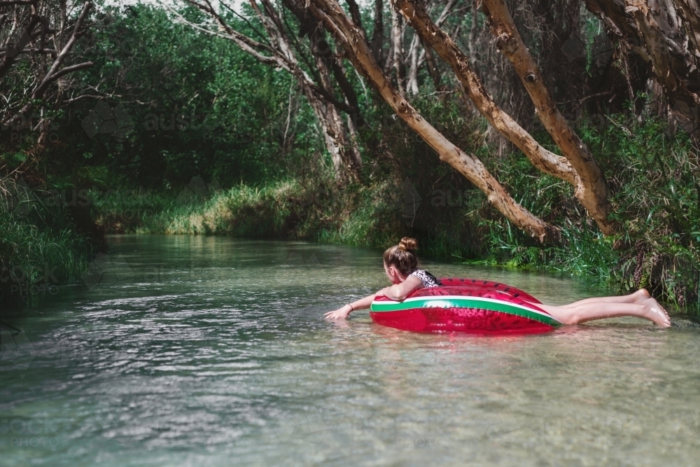 teens floating down Eli Creek, Fraser Island - Australian Stock Image