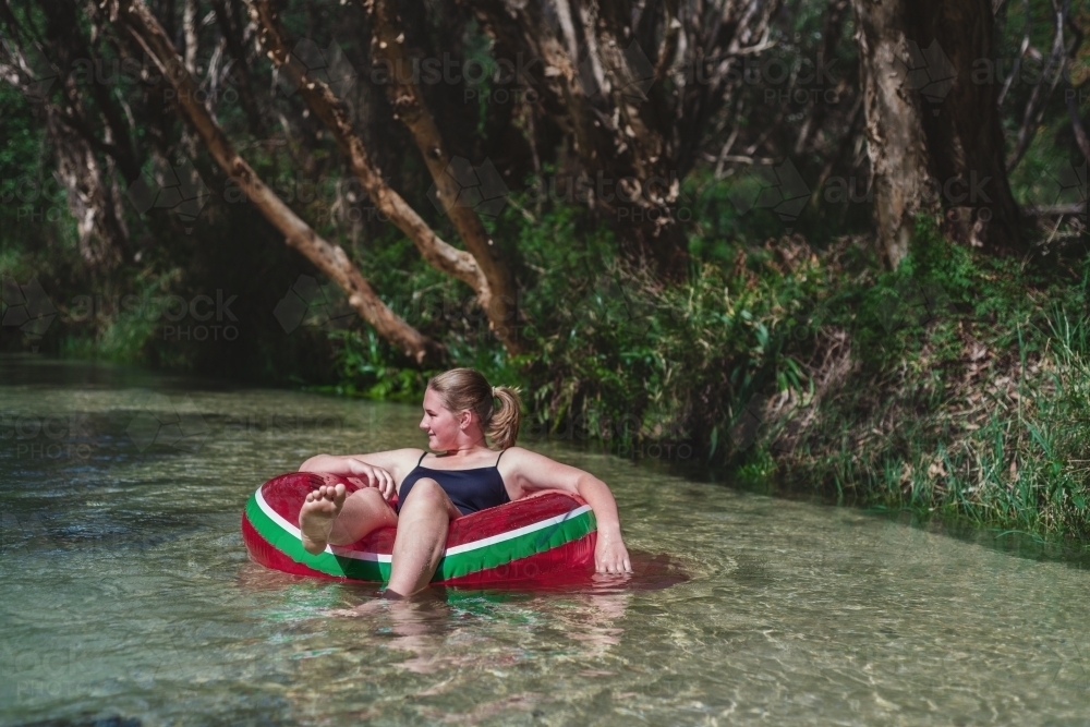 teens floating down Eli Creek, Fraser Island - Australian Stock Image